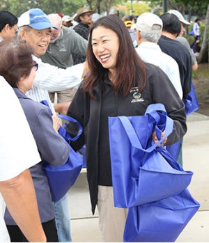 Janet Nguyen picks up bags of money in LIttle Saigon